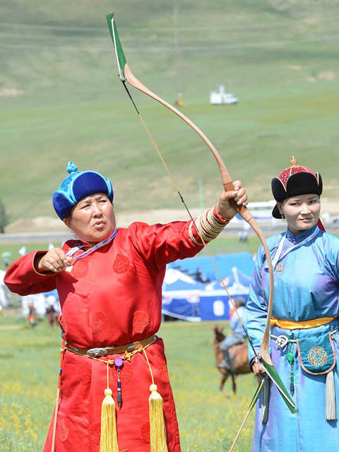 7月15日,在蒙古国首都乌兰巴托,蒙古族女射箭手表演射箭.