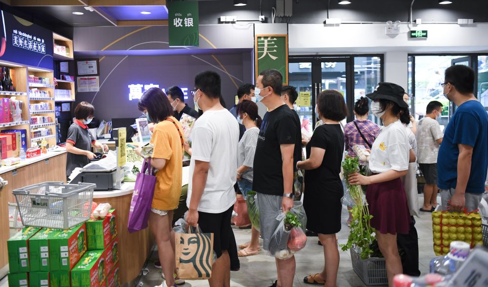 5月30日,市民在广钢新城一家社区超市排队结账.